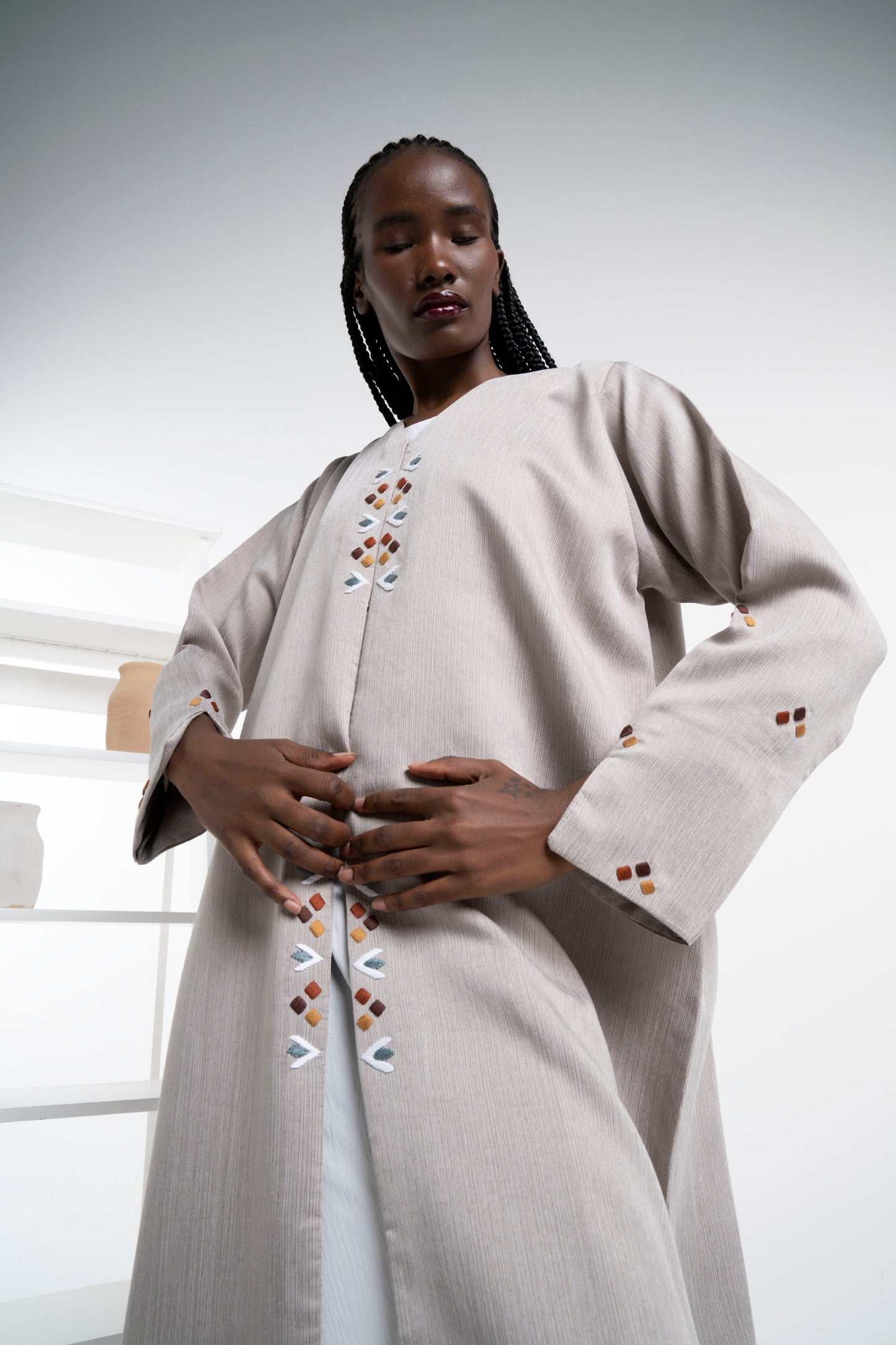 Detail view of thread embroidery on frontline and sleeves.