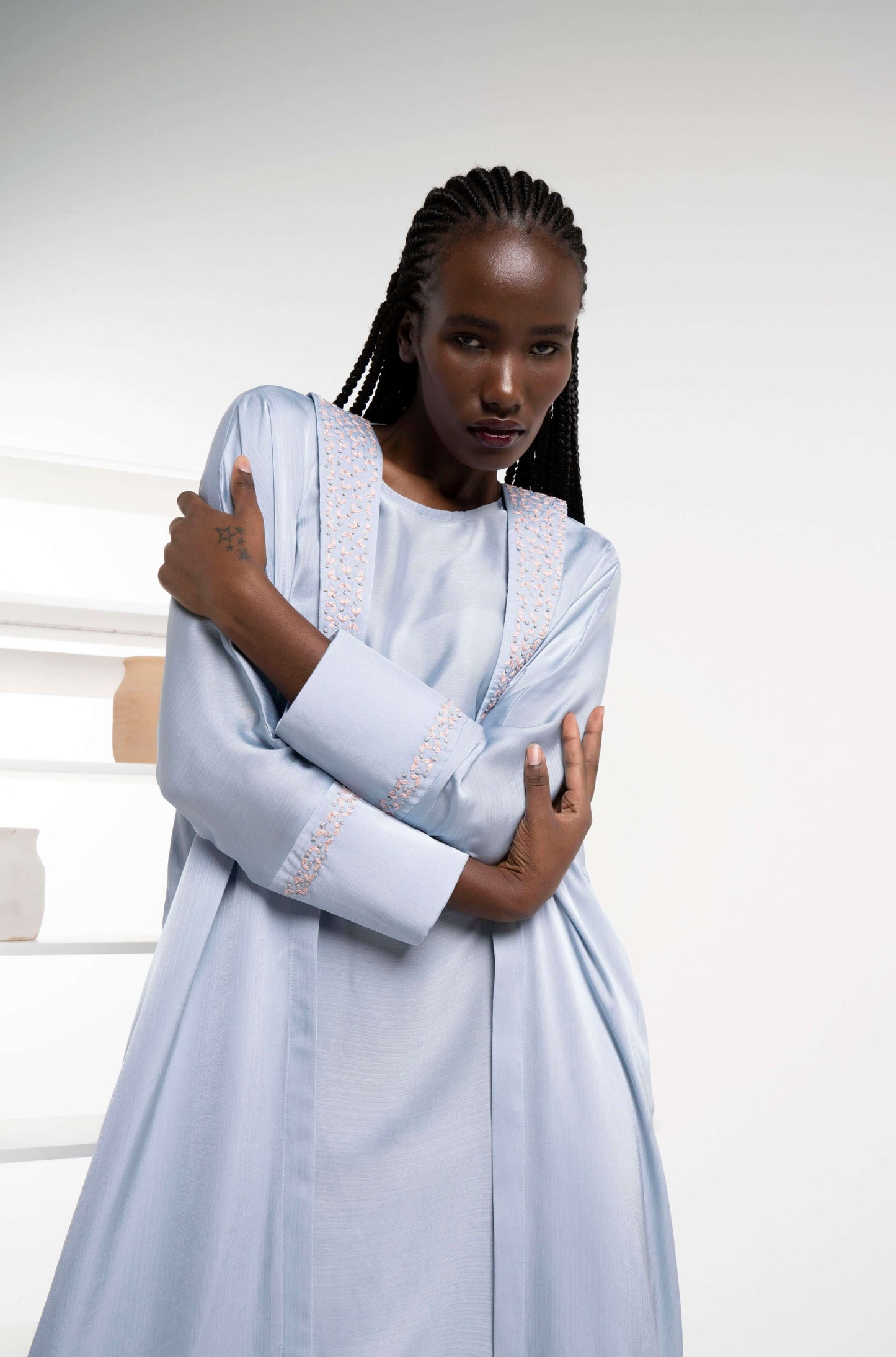 Silk satin abaya with floral embroidery.