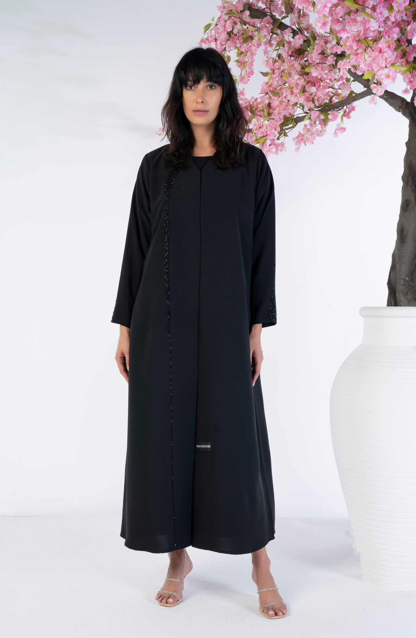 Girl wearing black abaya with bead work