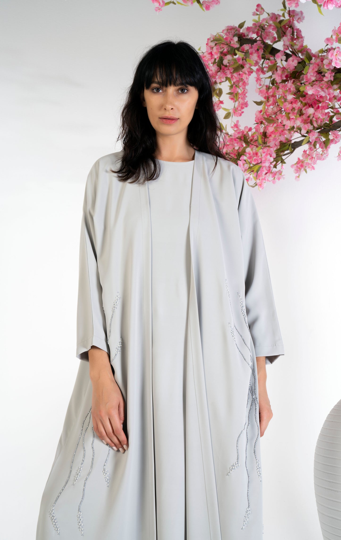 Girl wearing bisht abaya with floral embroidery on sides