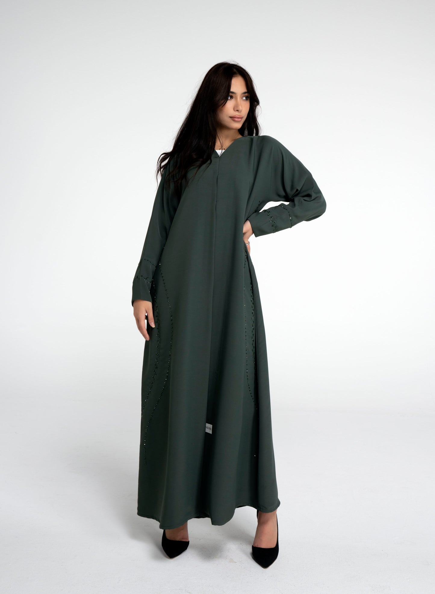 Green abaya with curve design embellishments on front side and sleeve