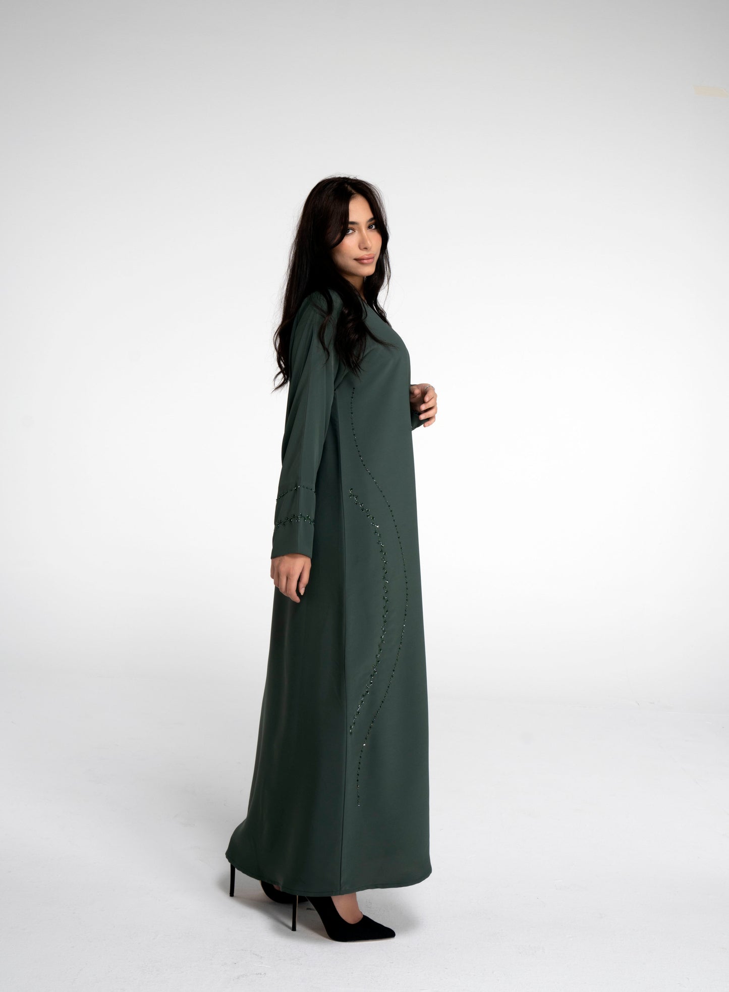 Green abaya with curve design and embellishments on front side and sleeve