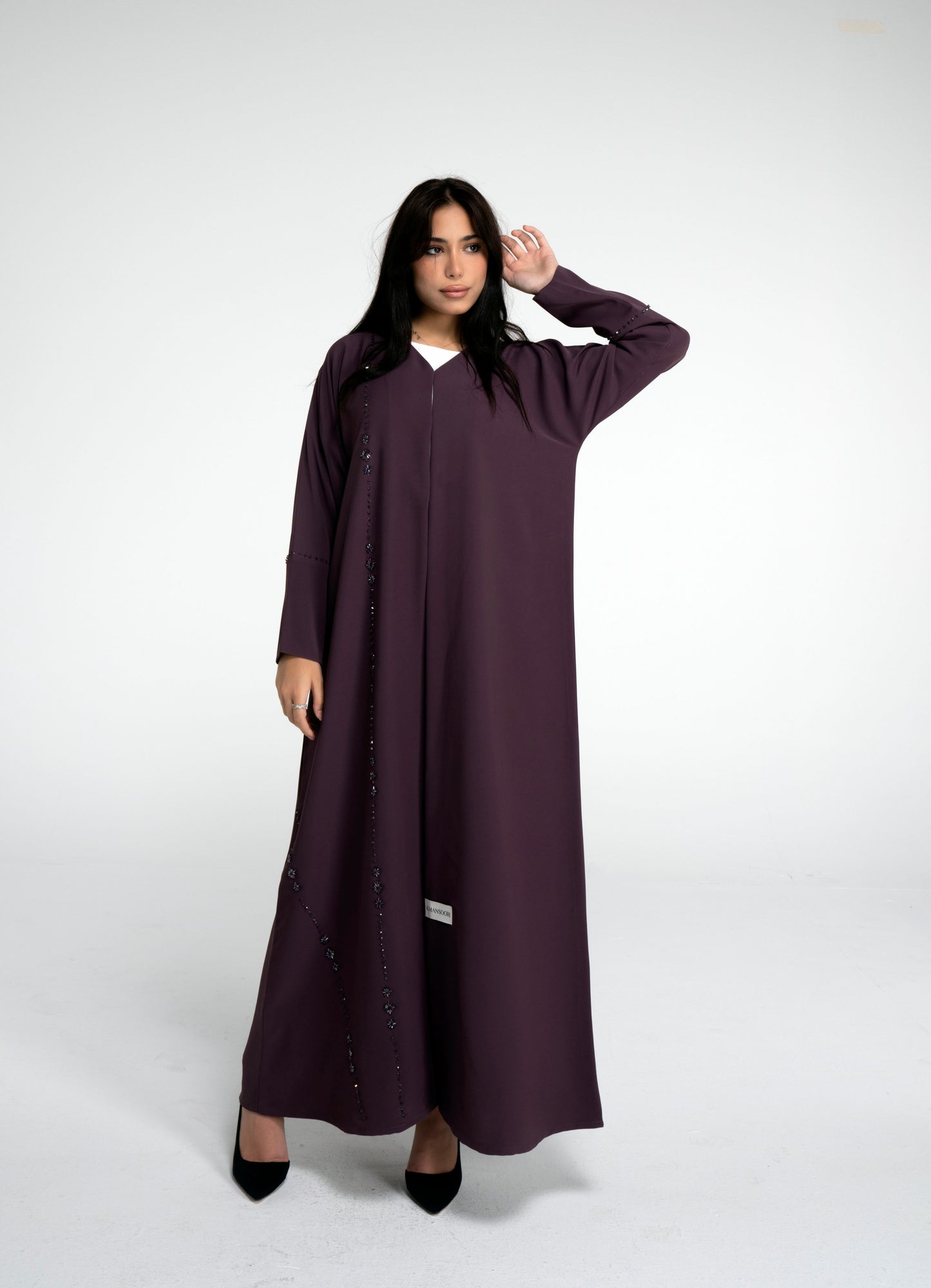 Girl wearing purple abaya with flower motif design line on front and simple bead line on sleeve
