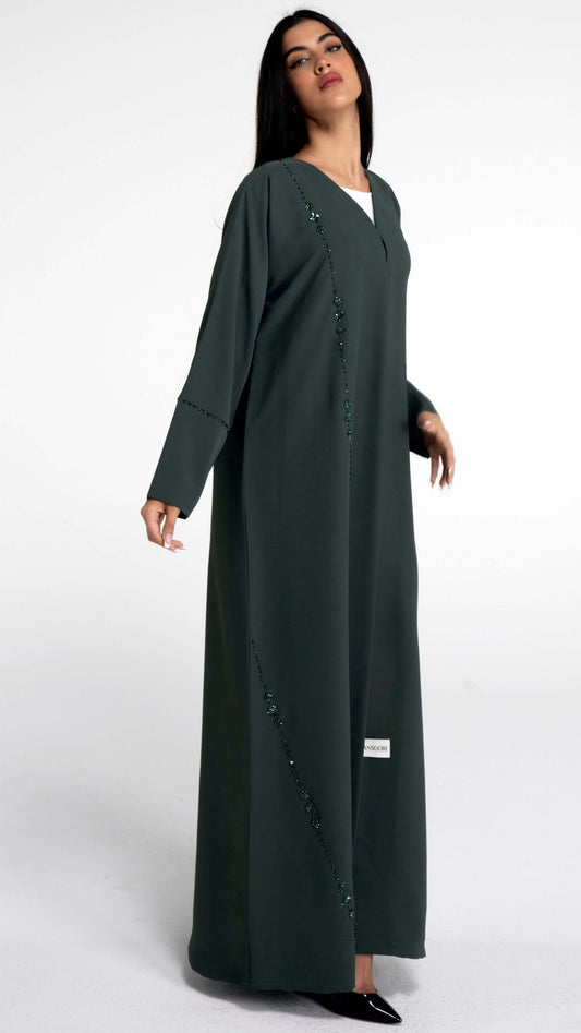 Girl wearing green abaya with flower motif design line on front