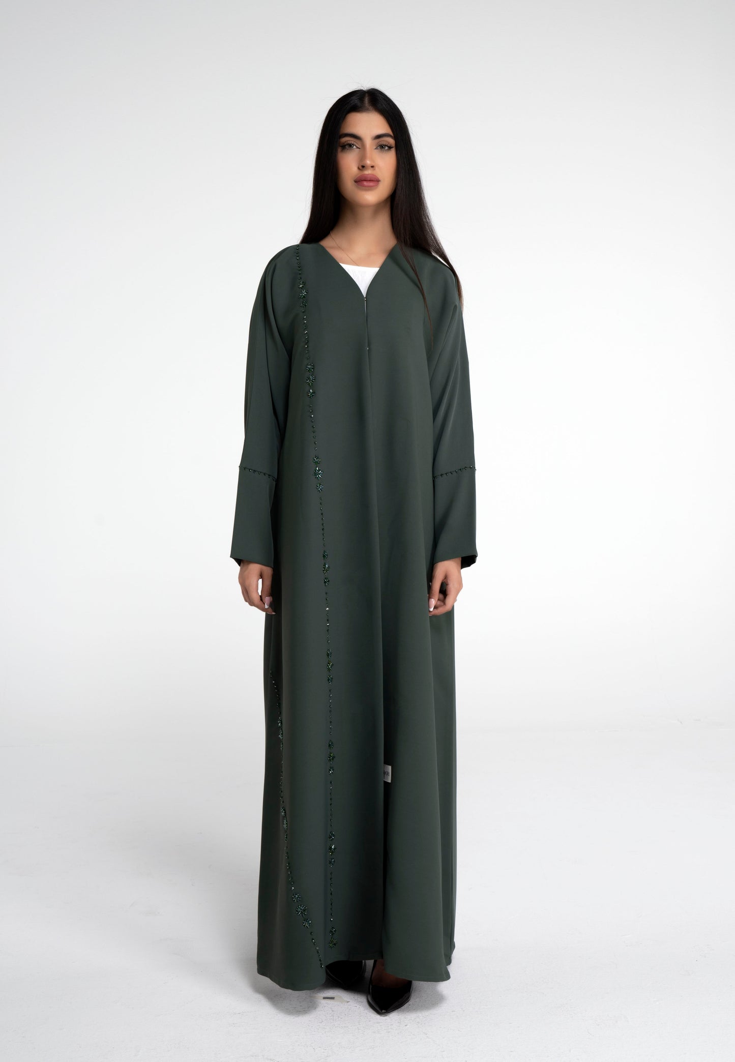 Detailed view of flower motif design line on front and simple bead line on sleeve