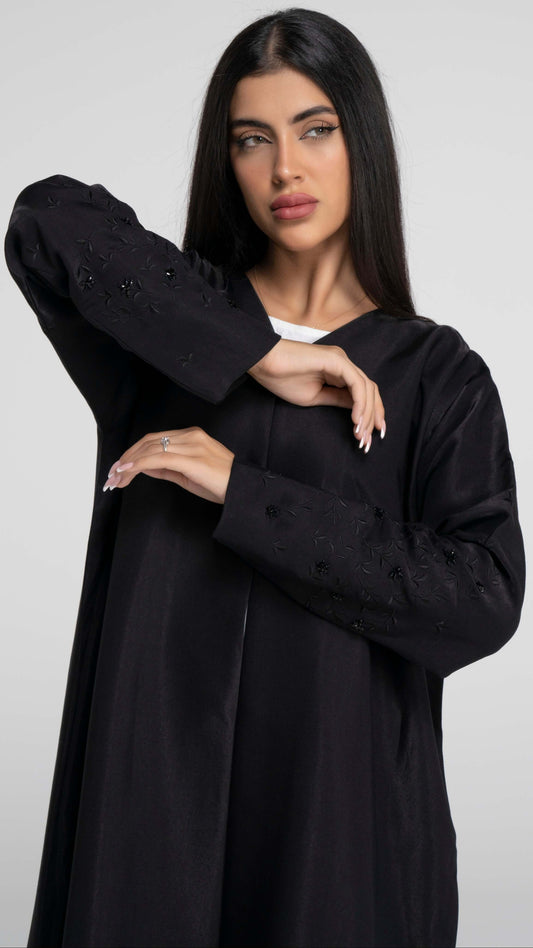 Black abaya with floral thread embroidered sleeves.