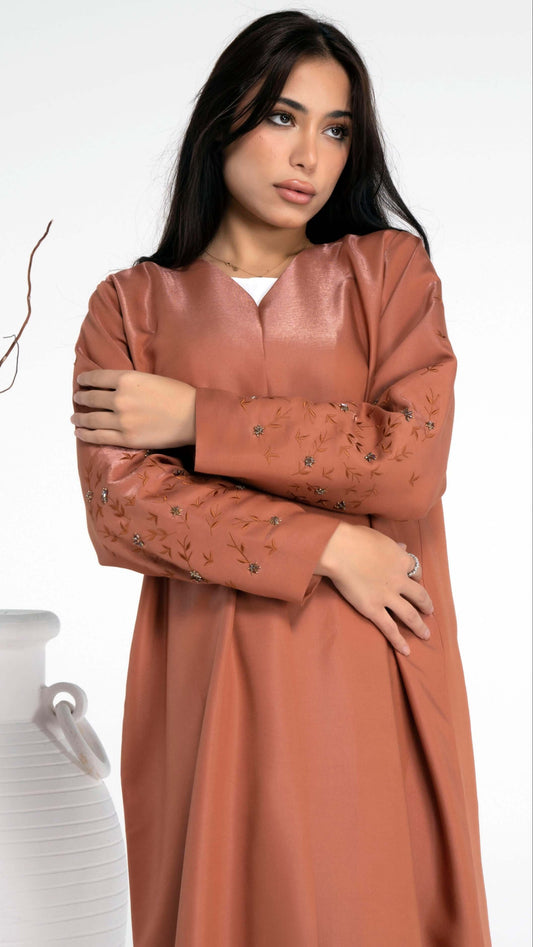 Detailed view of thread floral embroidery sleeve with bead embellishment.