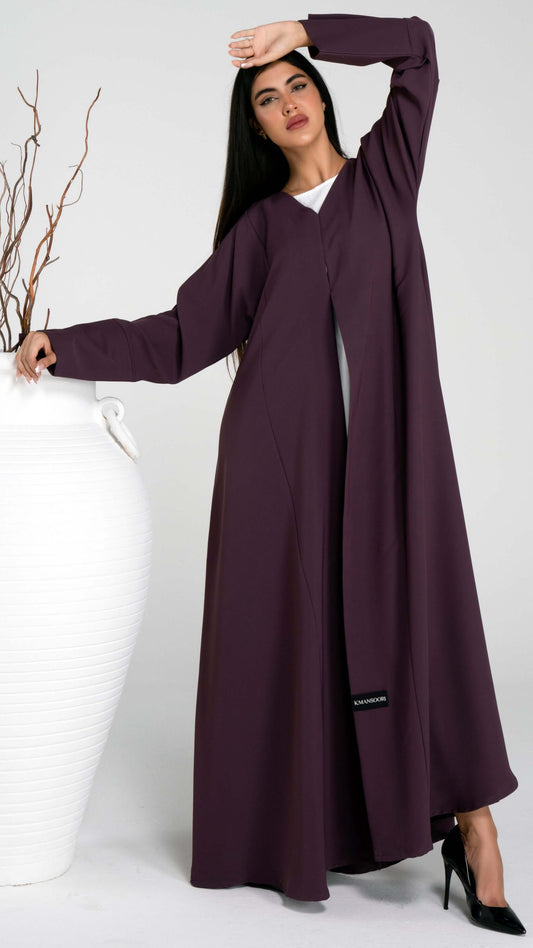 Girl wearing purple abaya with stylized pattern sleeve