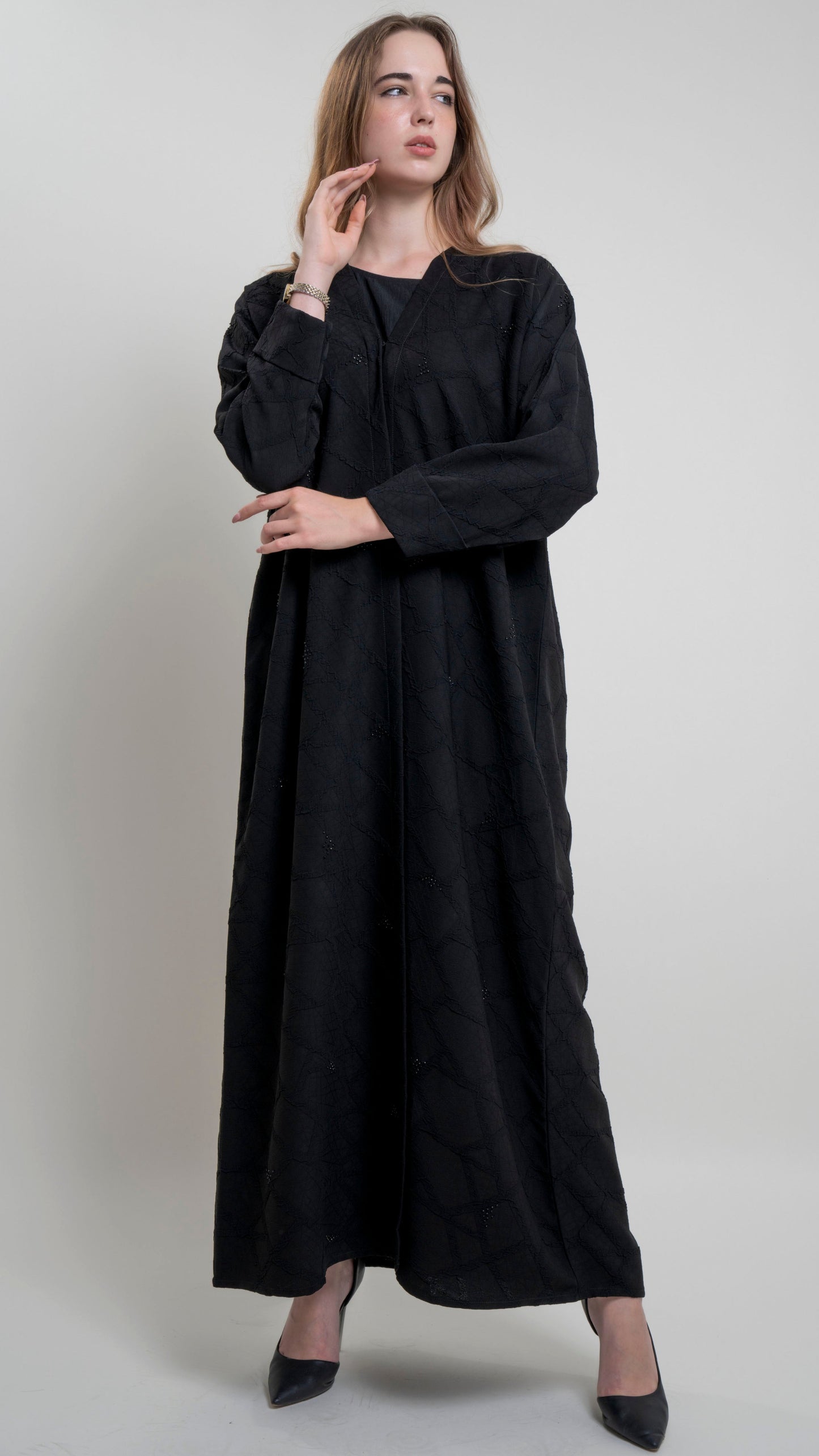 Girl wearing Bisht black Abaya with Simple Bead Highlights