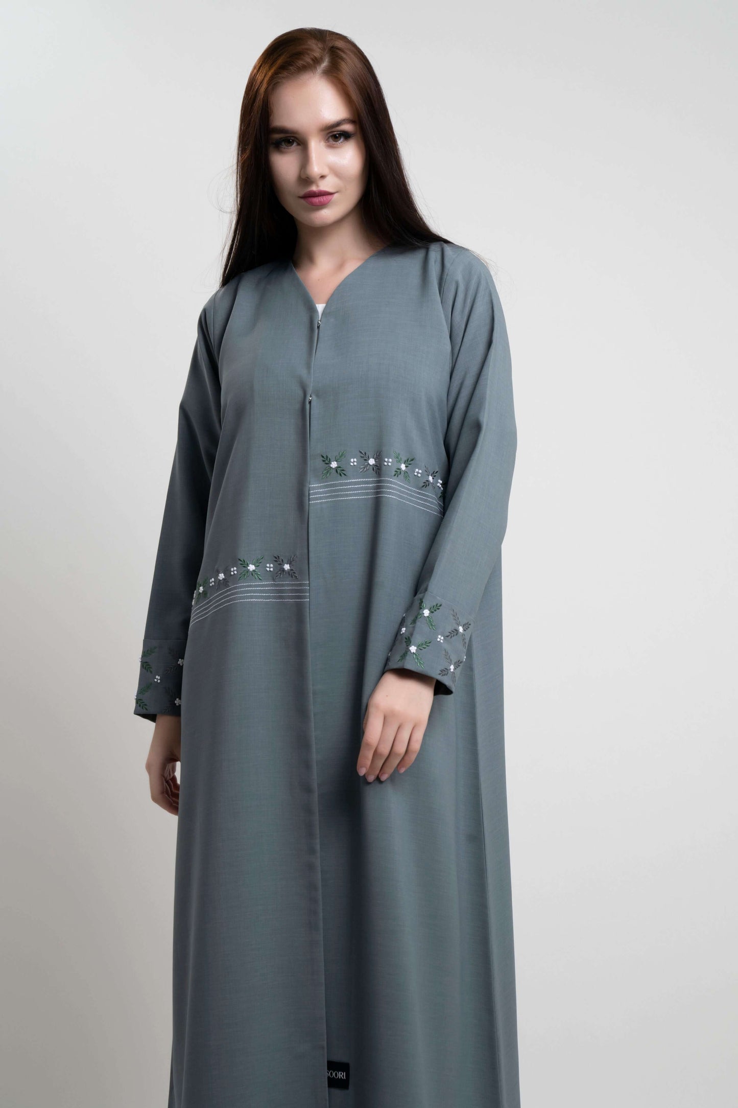 Green abaya with floral thread embroidery.