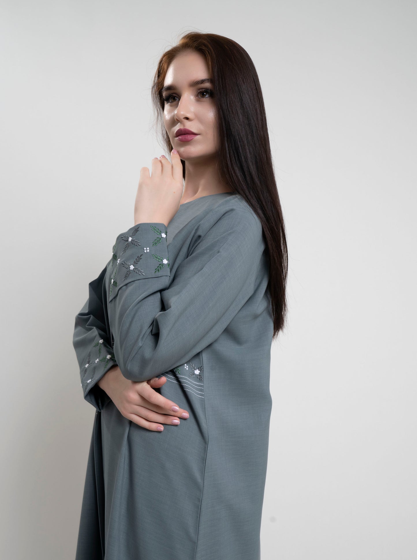 Floral thread embroidery on fold sleeve.