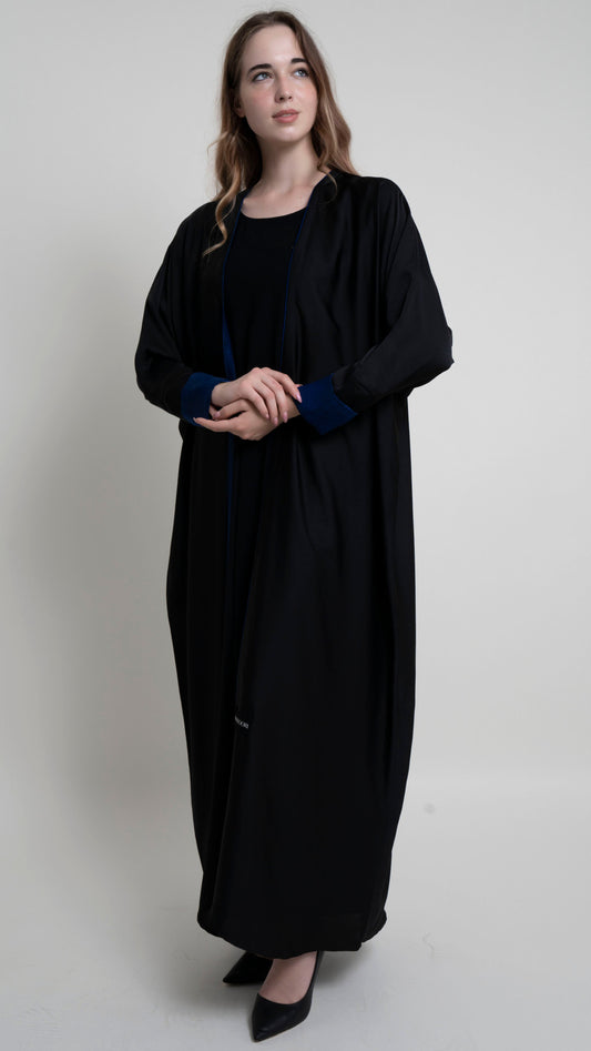 Girl wearing black bahrini style abaya with blue color cuff sleeve and piping on front line