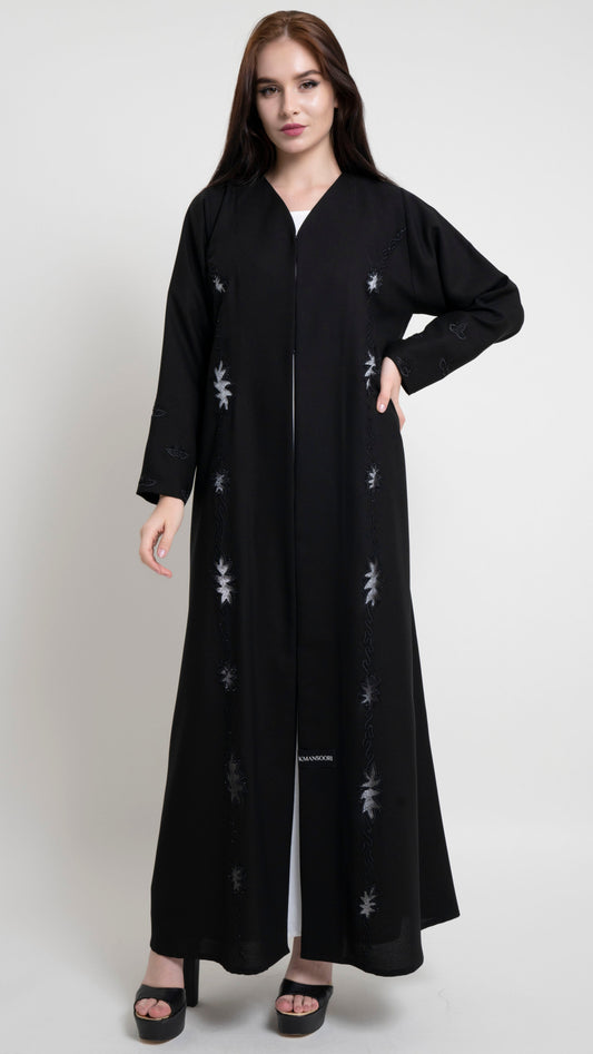 Girl wearing black net abaya with embroidery and bead detailing