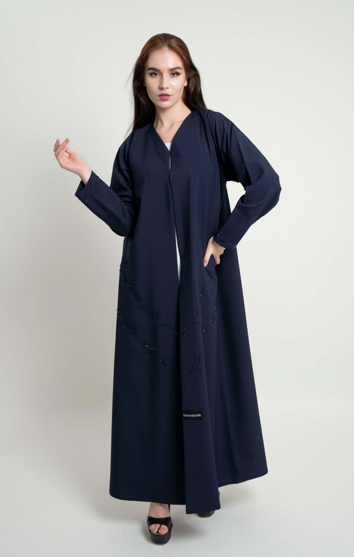 Dark blue abaya with curved bead embellishment on front and sleeve