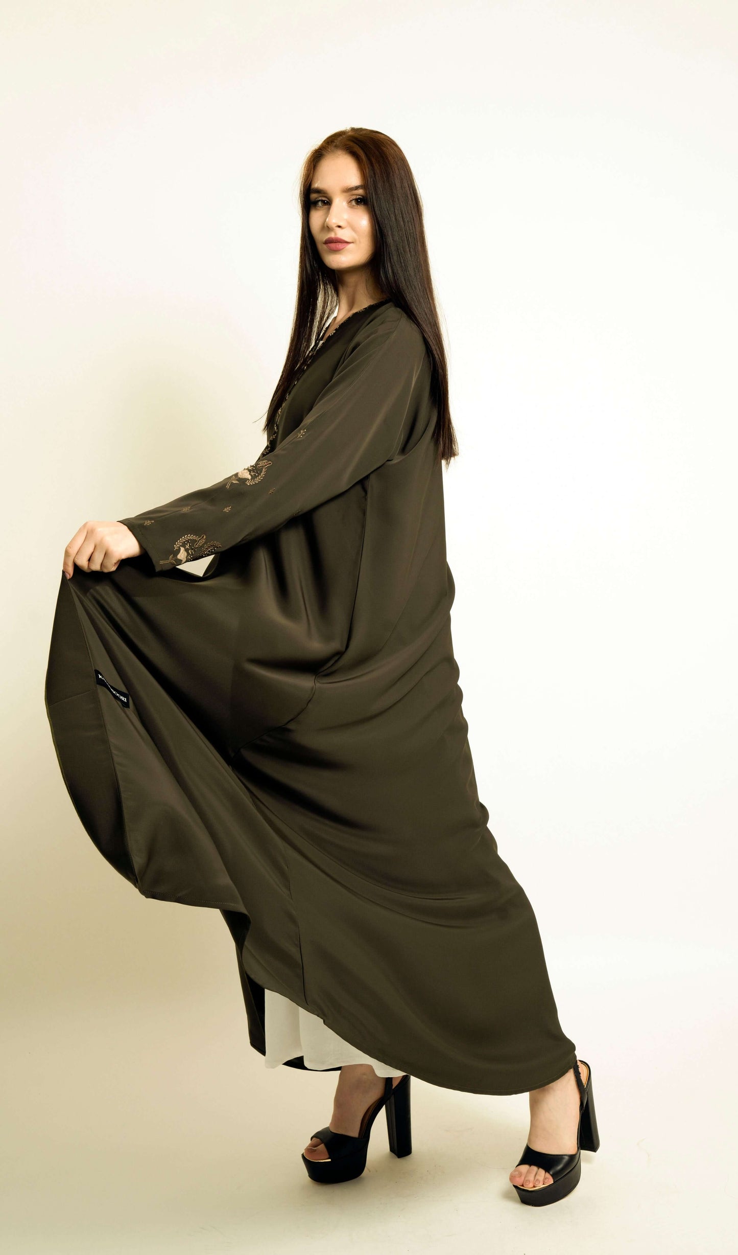 Flow of green abaya with embroidered neckline and floral motif sleeves