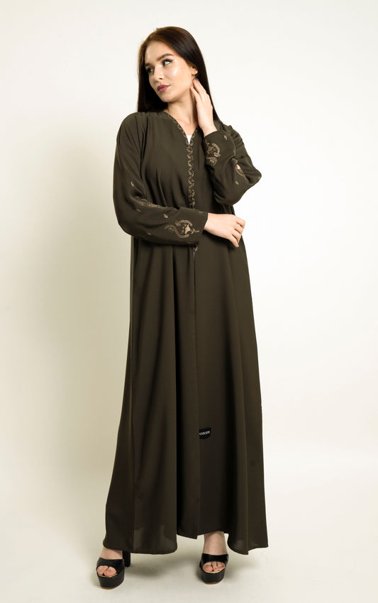 Girl wearing green abaya with embroidered neckline and floral motif sleeves