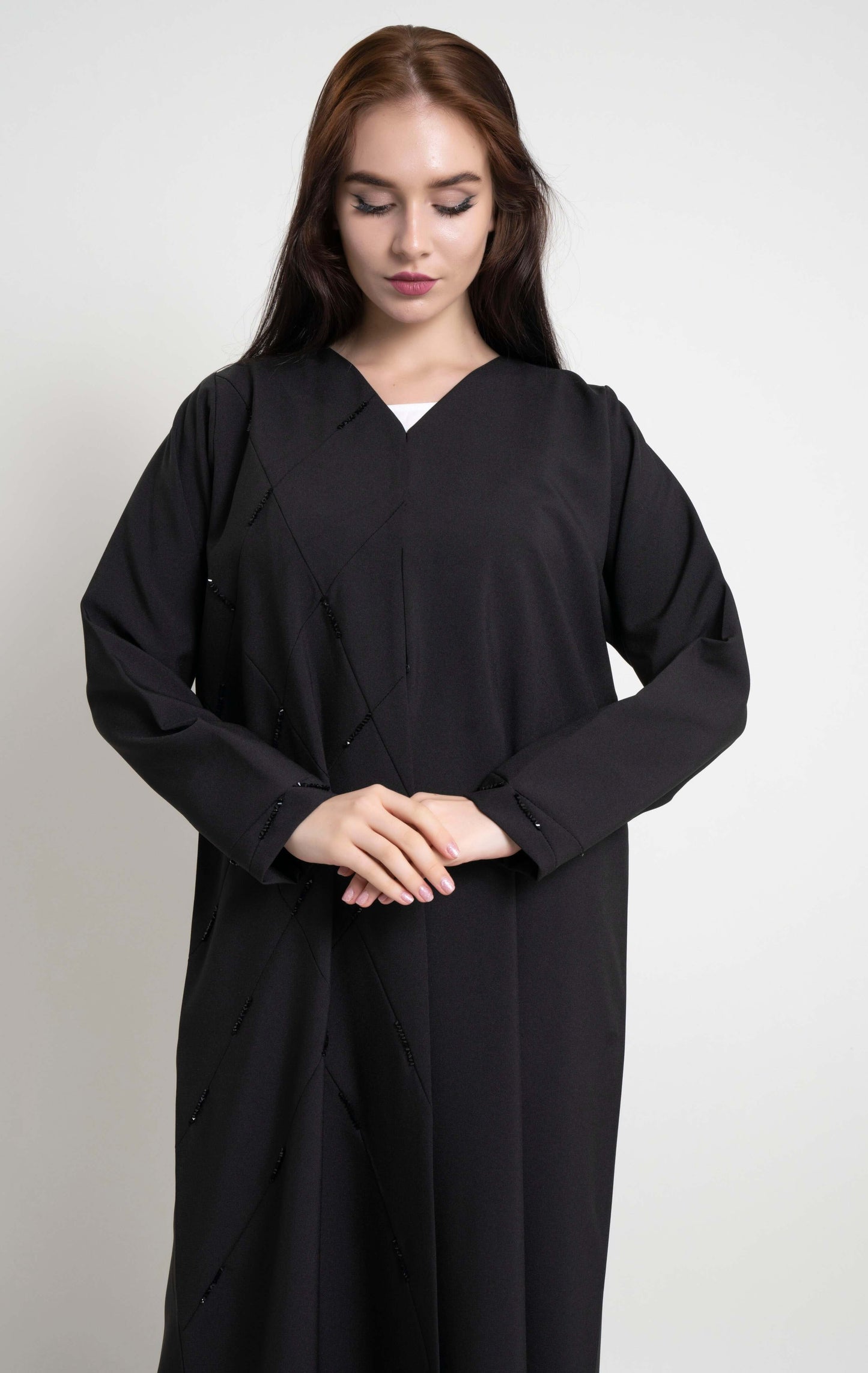 Detailed view of abaya in Dubai online with geometric pintucks and embellished with bead detailing