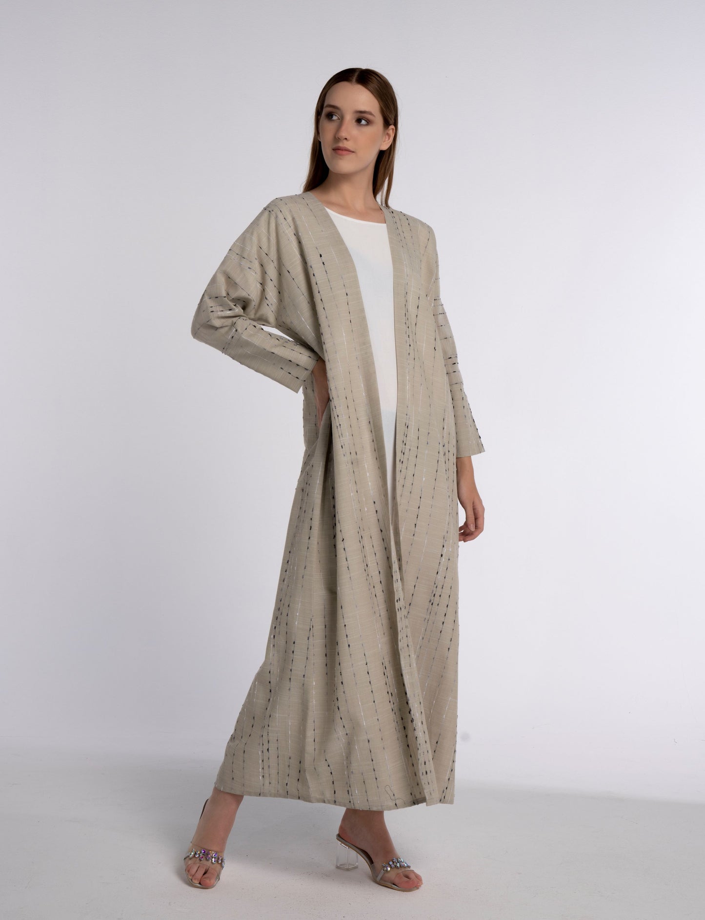 Girl wearing beige abaya for women.