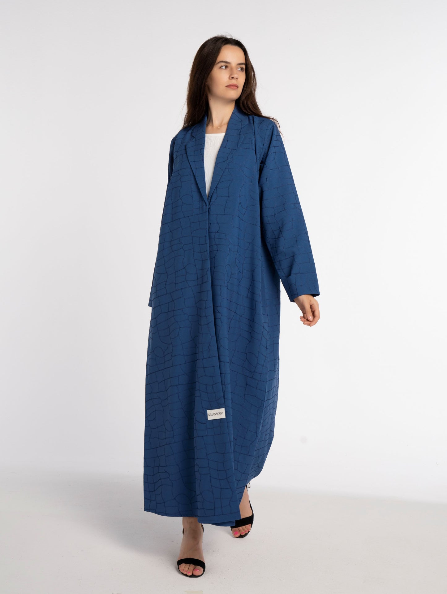 Girl wearing sky blue machine printed abaya with white pattern.