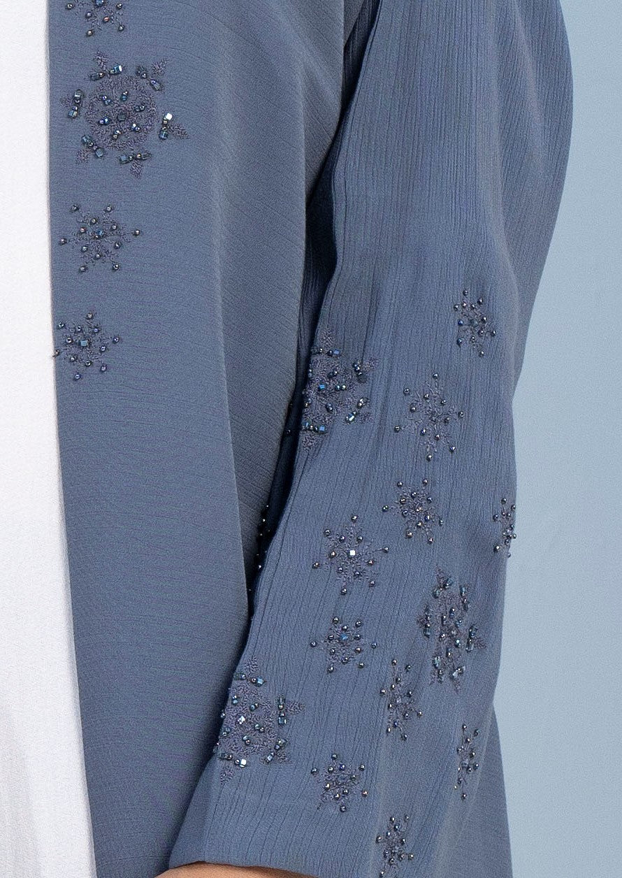 Snowflake embroidery and embellishments on top front flap and sleeves