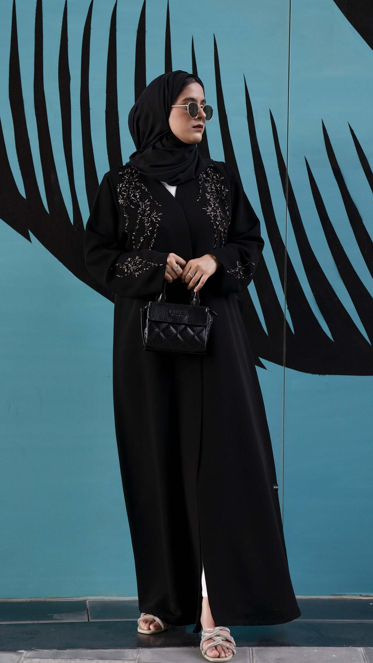 Women wearing Elegant black abaya with coloured bead detailing