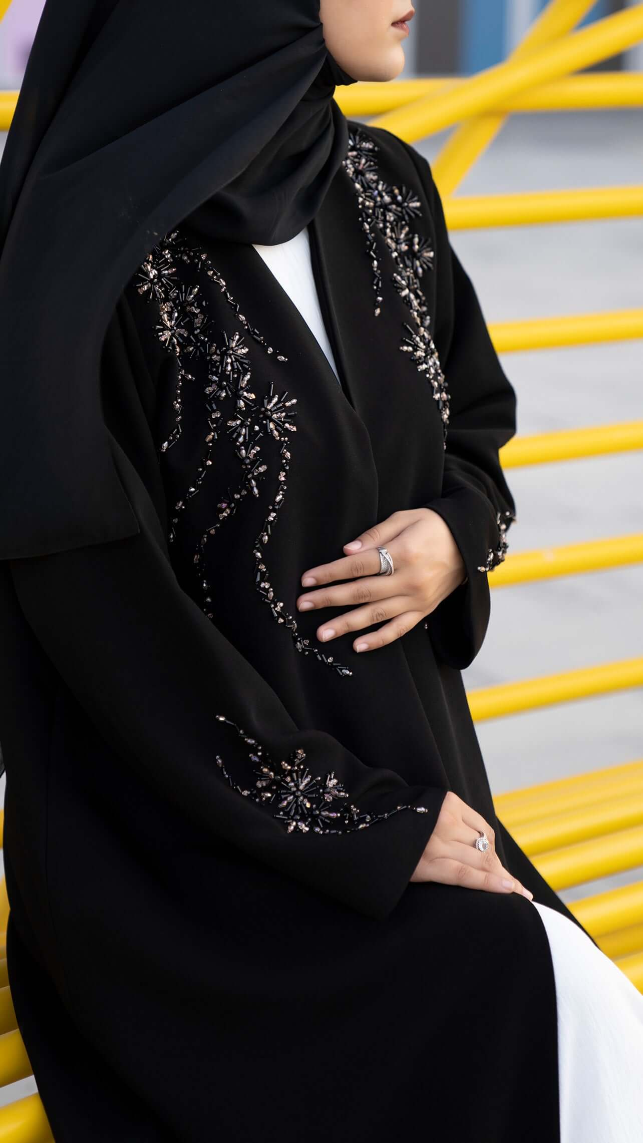 Women wearing Elegant black abaya with coloured bead detailingWomen wearing Elegant black abaya with coloured bead detailing