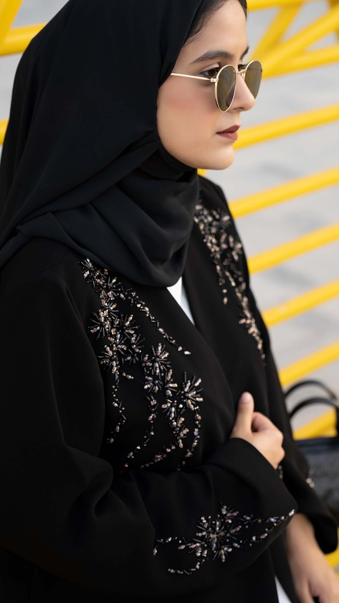 Women wearing Elegant black abaya with colored bead detailing