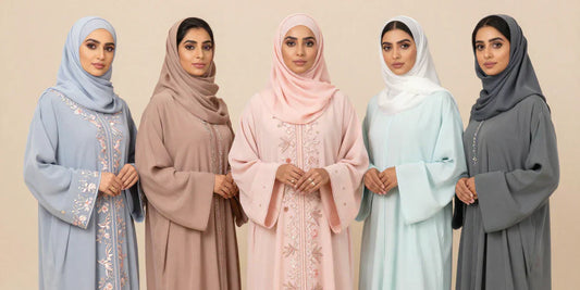 women wearing different colour abayas