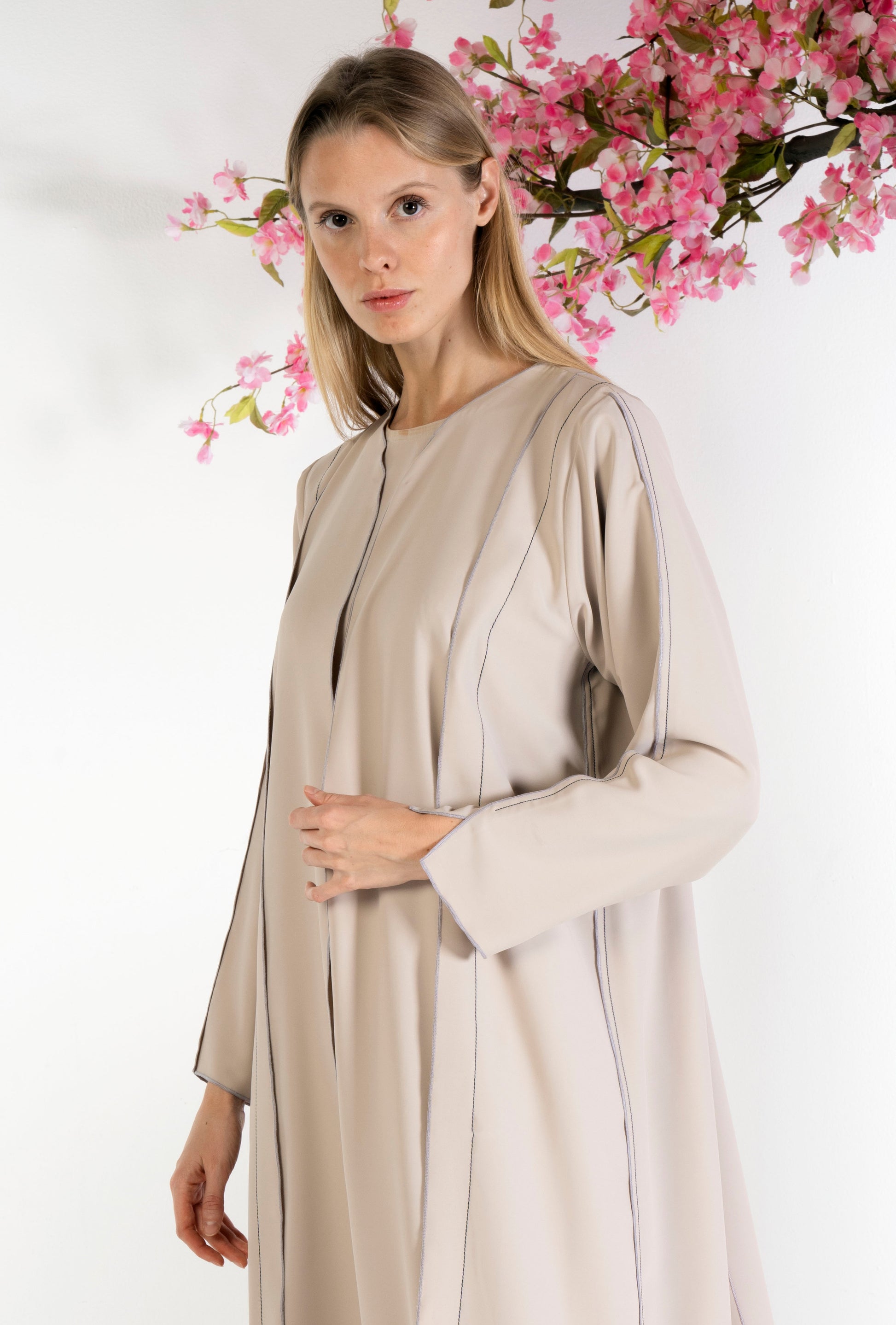 Stylised pattern beige abaya with contrast color stitch line 