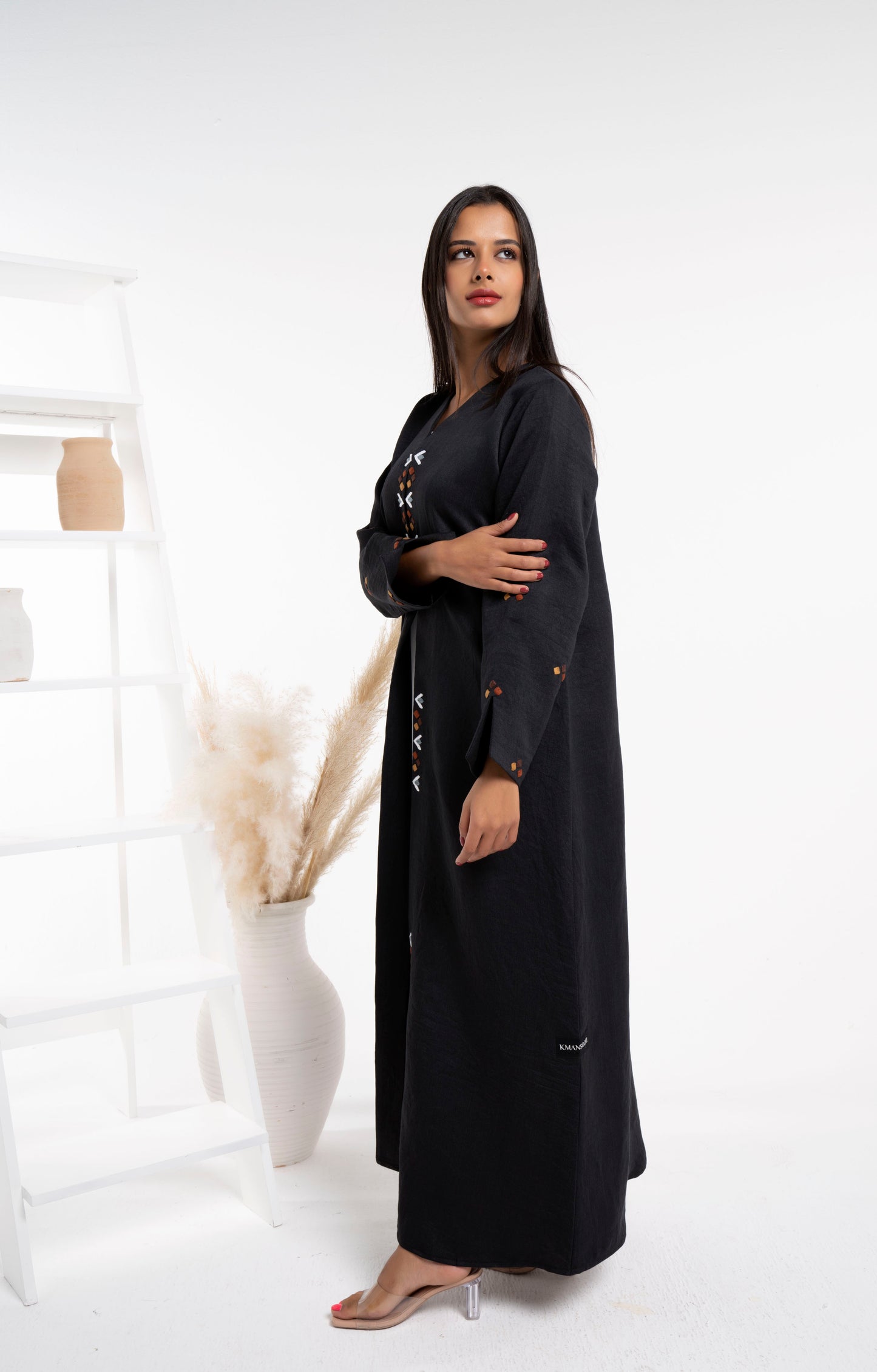 Girl wearing black abaya with thread embroidery on frontline and sleeves