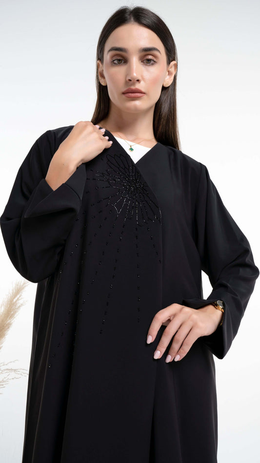 Girl wearing black abaya with bead design