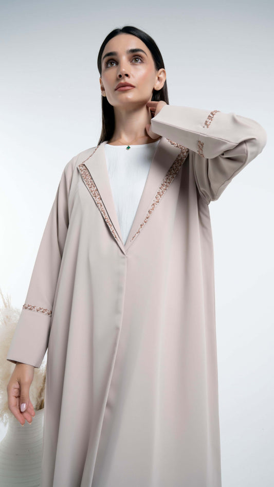 Floral embroidery detailing on sleeves and collar of the abaya