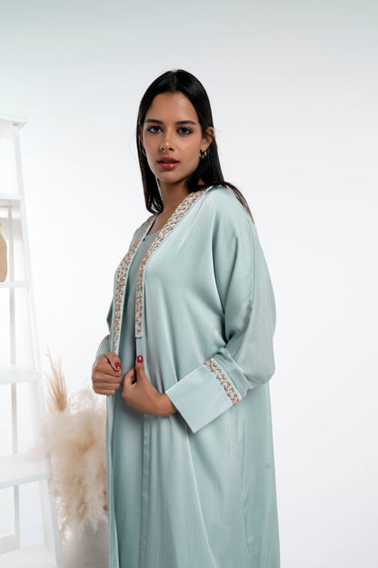 Girl wearing silk satin abaya with floral embroidery on collar and cuff sleeves