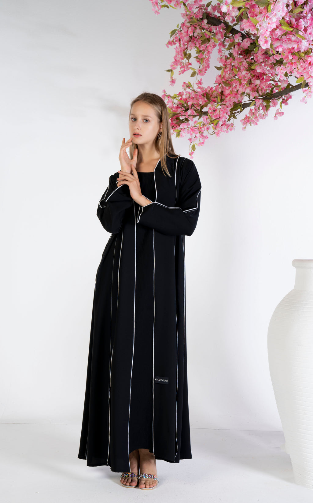 Black abaya with stylised pattern and contrast color stitch line