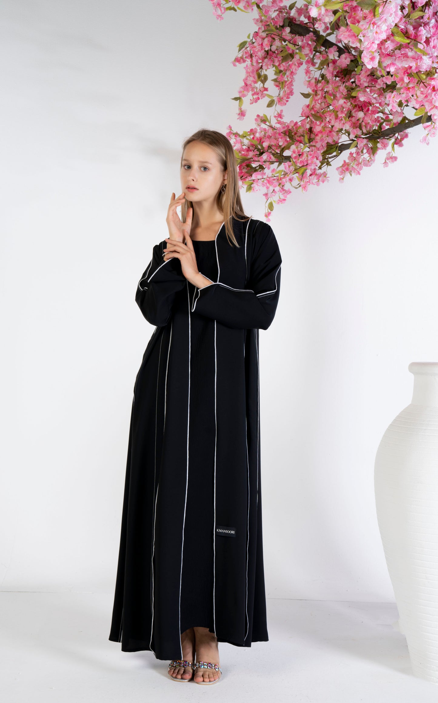 Black abaya with stylised pattern and contrast color stitch line