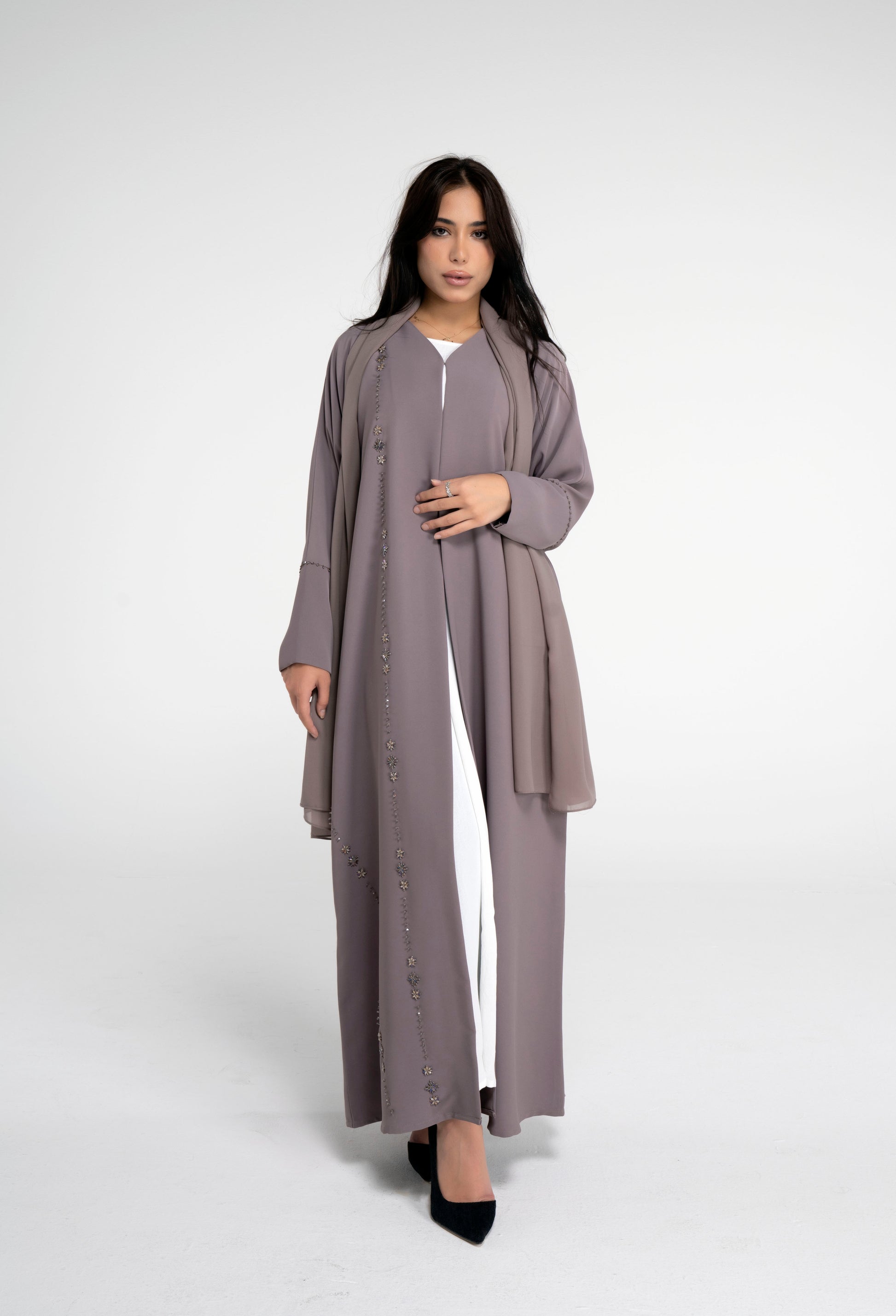 Brown abaya for women with flower motif design line on front and simple bead line on sleeve.