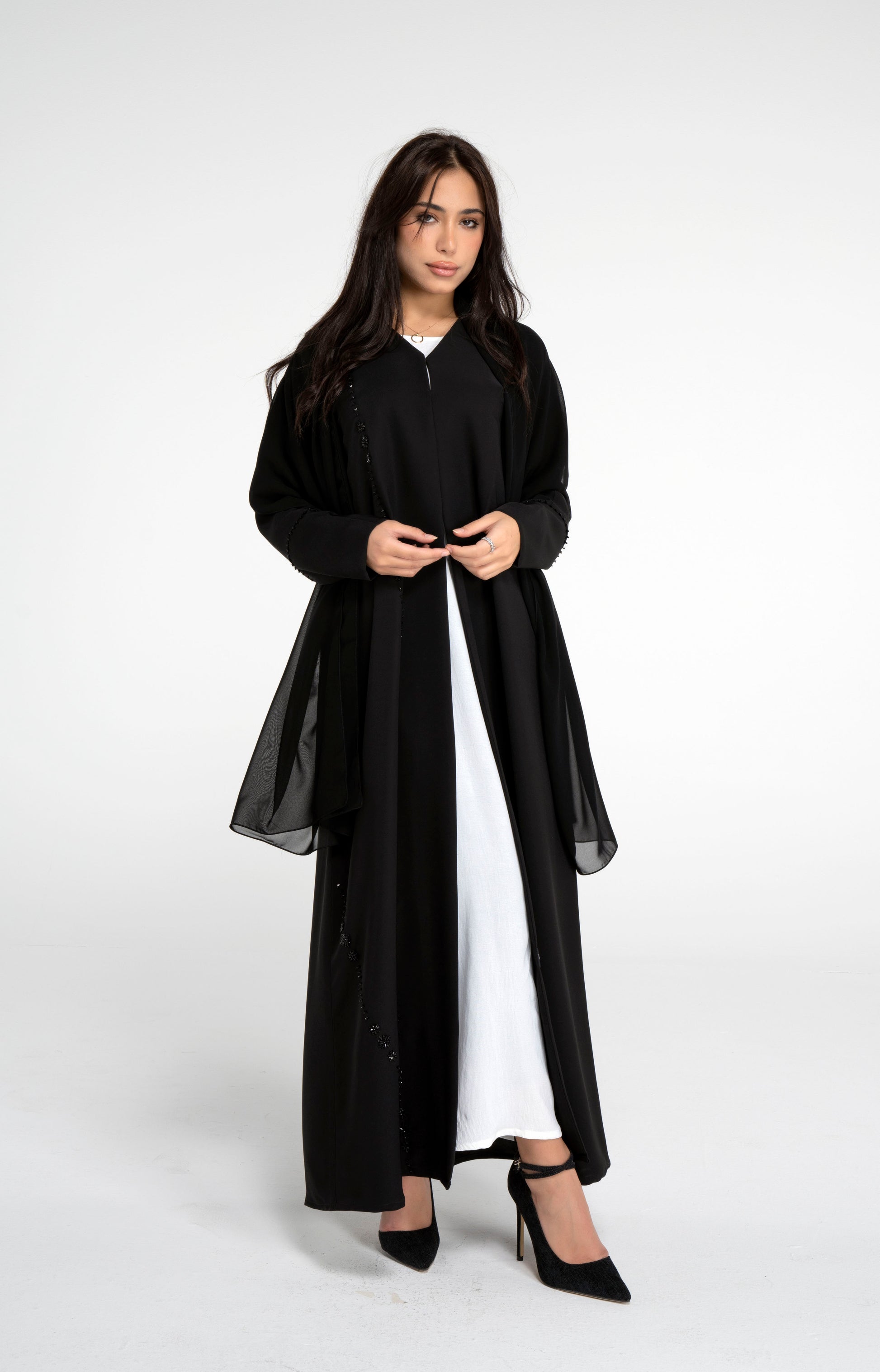 Girl wearing black abaya with flower motif design line