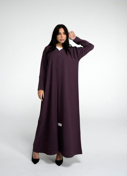 Girl wearing purple abaya with flower motif design line on front and simple bead line on sleeve