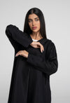 Black abaya with floral thread embroidered sleeves.