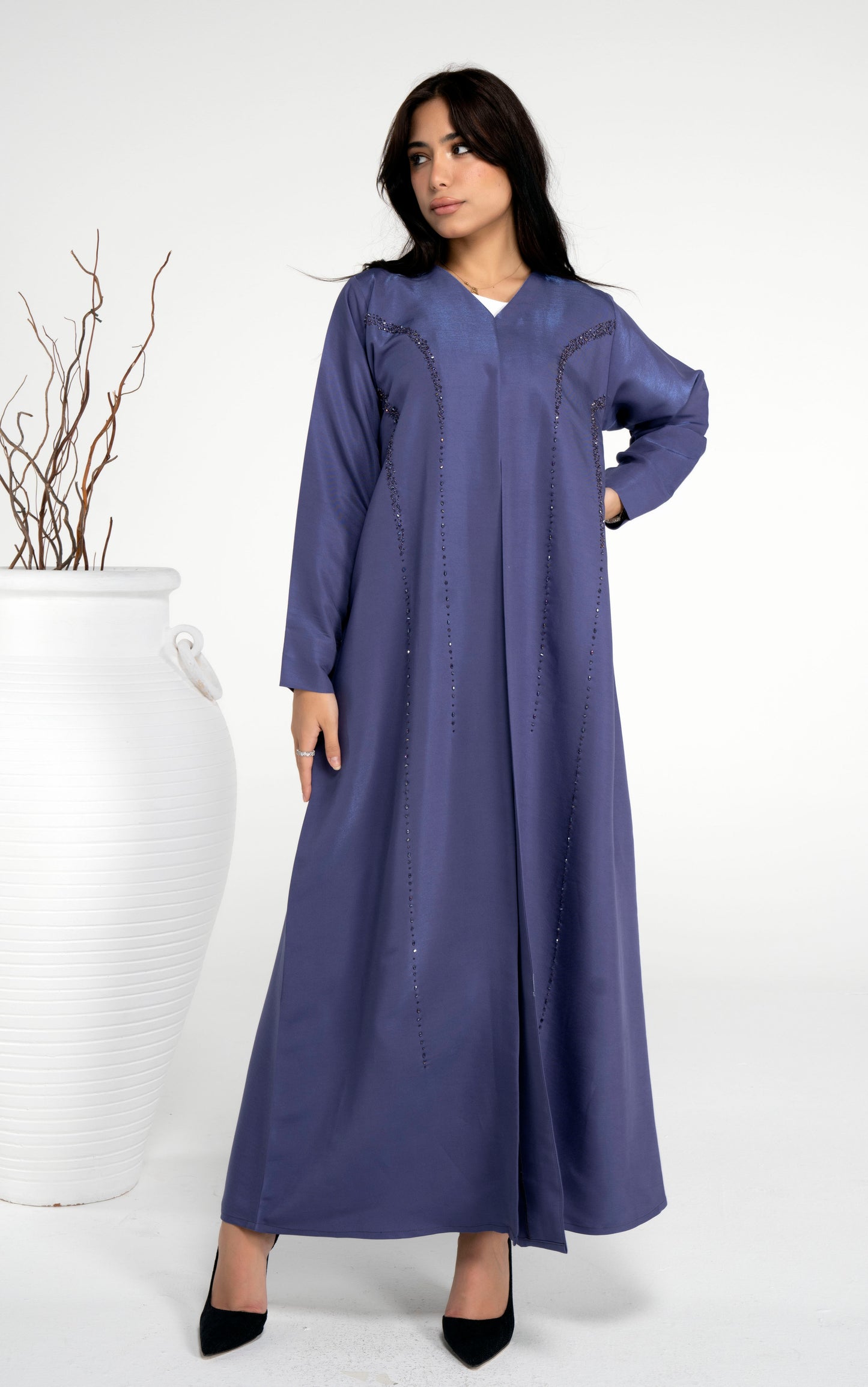 Girl wearing blue abaya with princess line bead embellishments