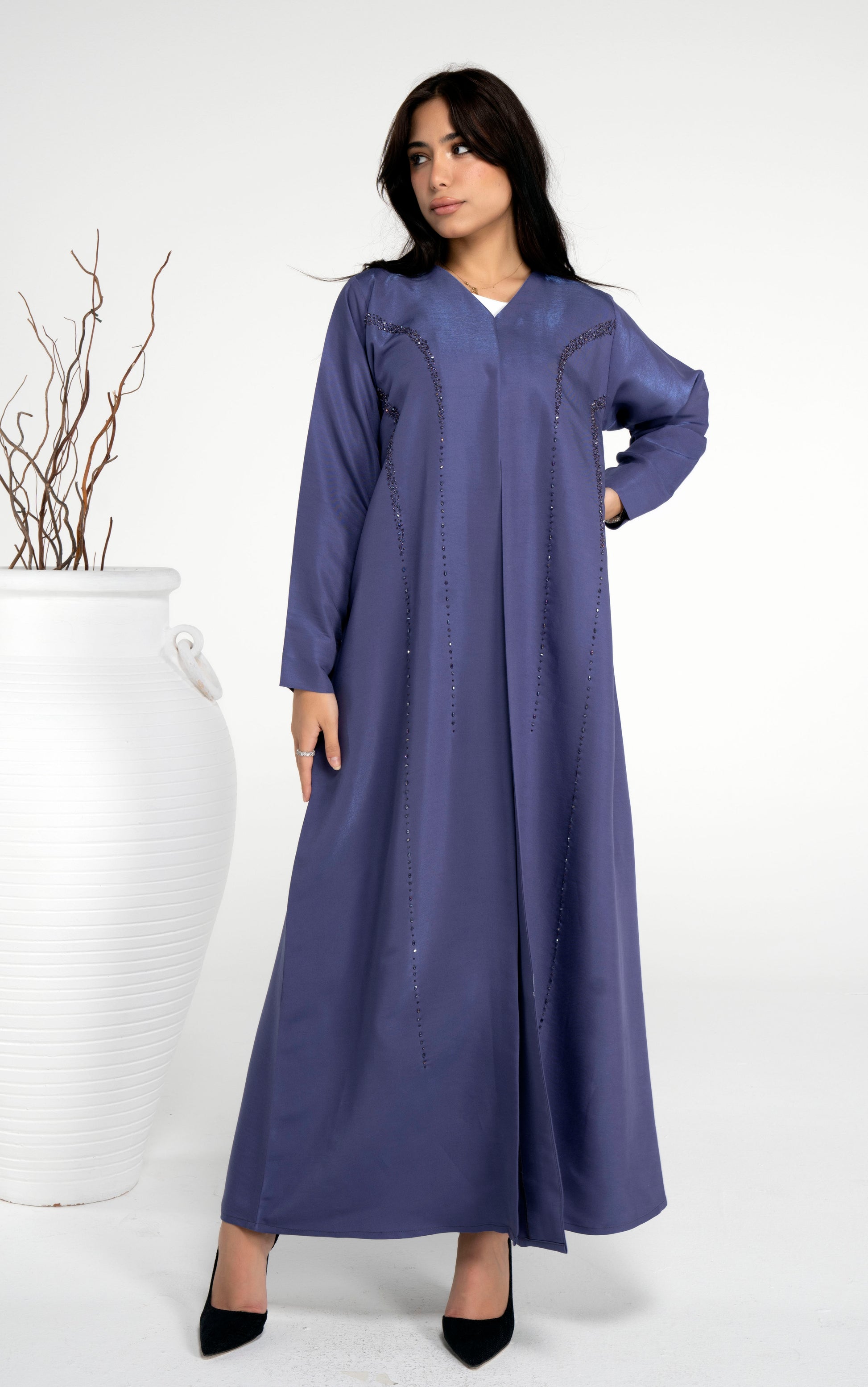 Girl wearing blue abaya with princess line bead embellishments