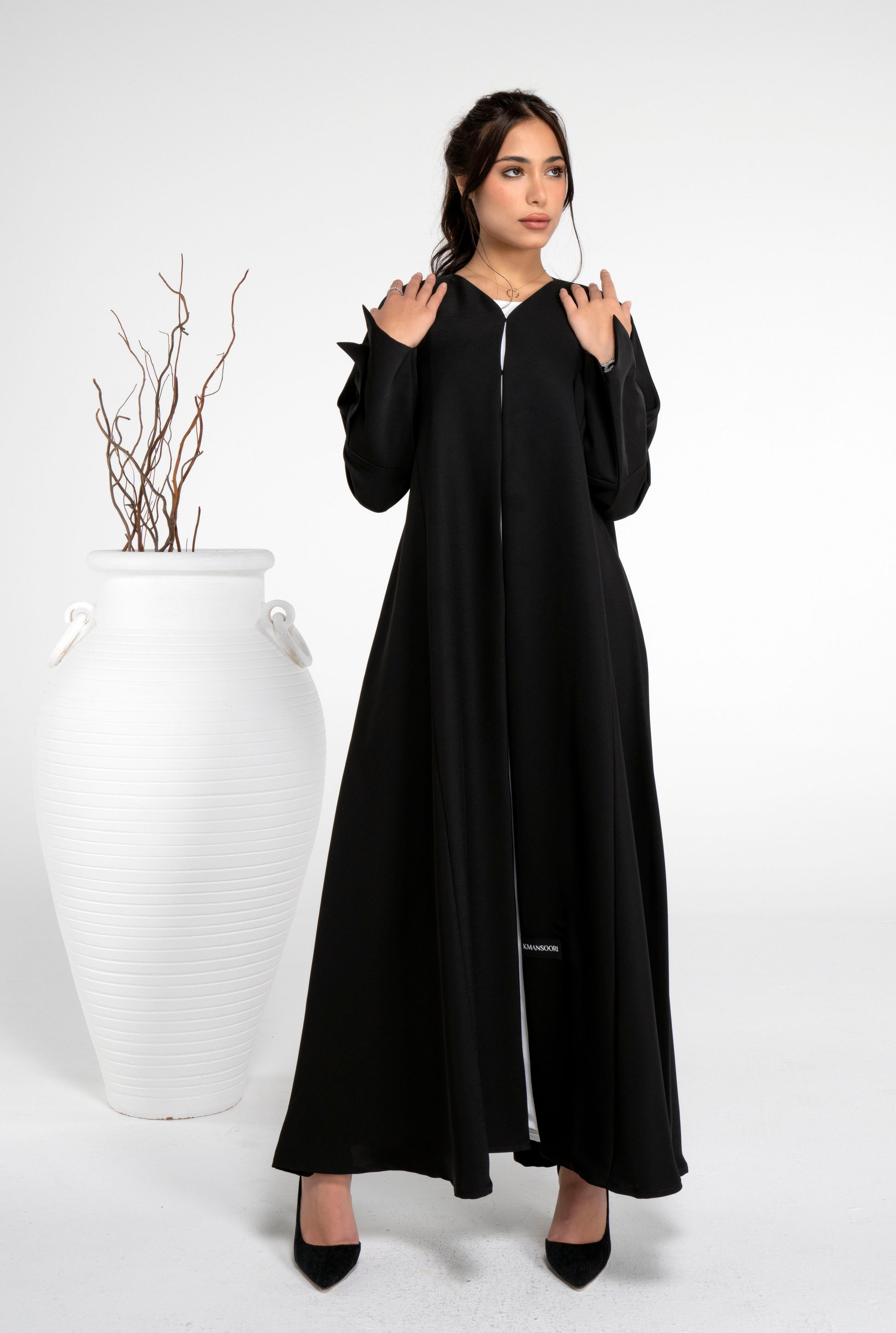 Girl wearing Black abaya with stylized pattern sleeve