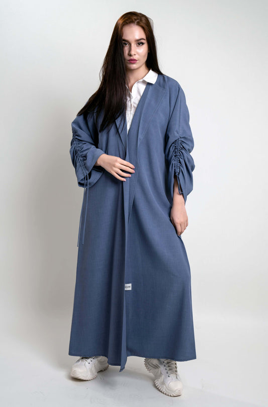 Girl wearing blue abaya with collar and frilled drawstring sleeve pattern