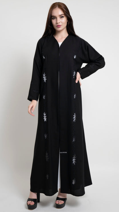 Girl wearing black net abaya with embroidery and bead detailing