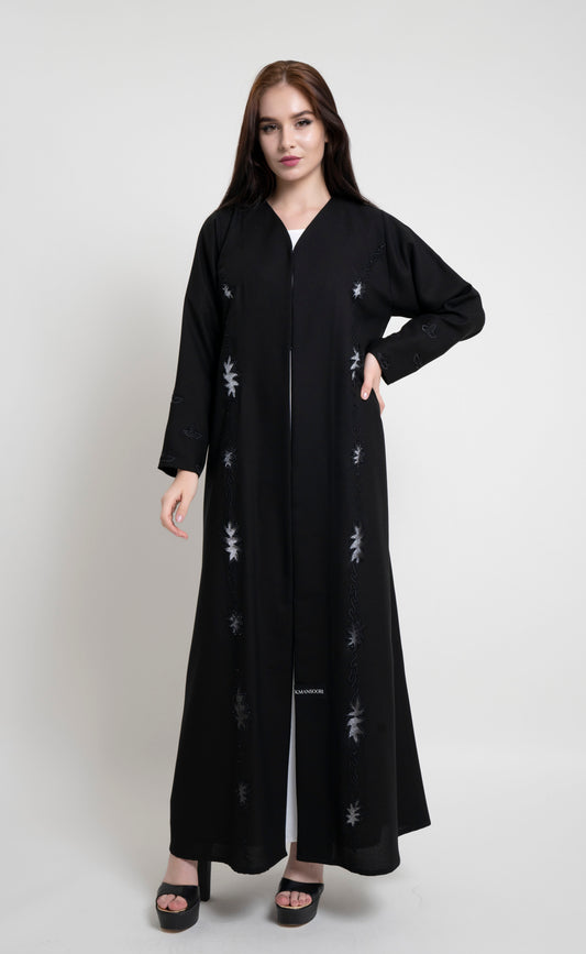 Girl wearing black net abaya with embroidery and bead detailing