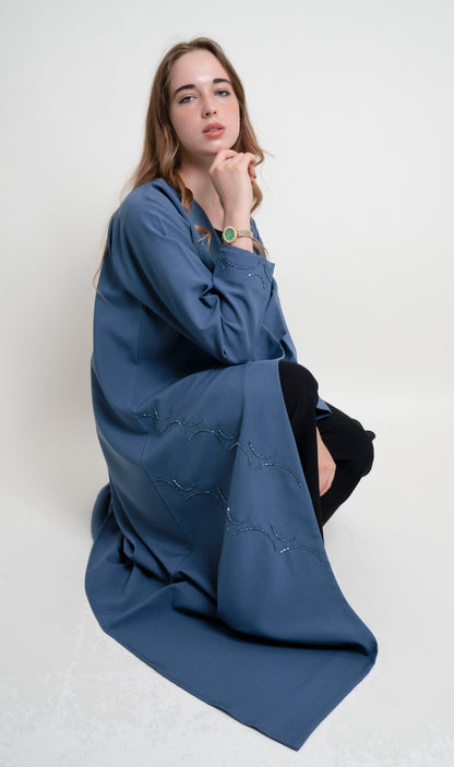 Girl wearing sky blue curve designed abaya with bead embellishment 