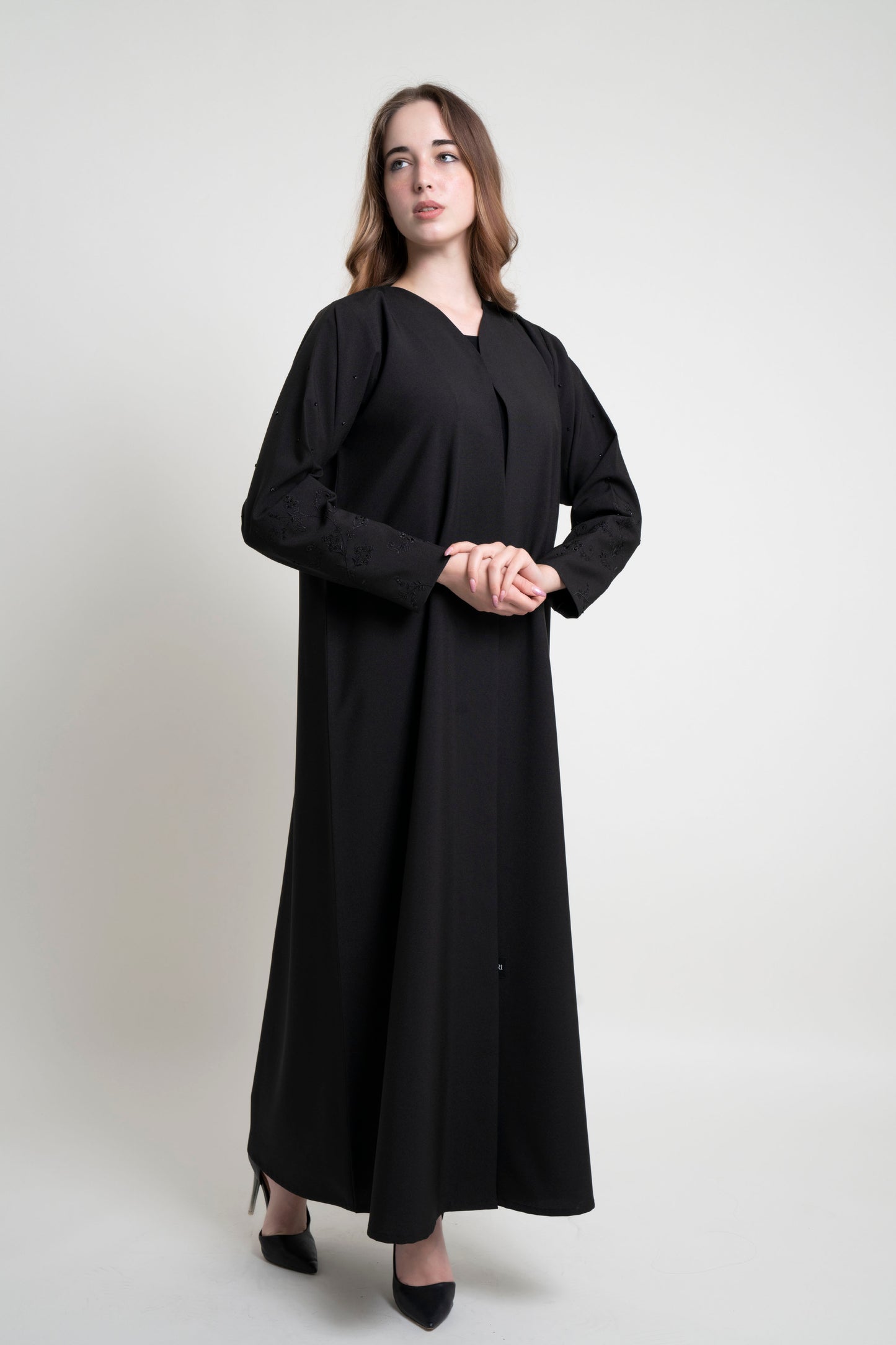 Girl wearing black abaya with floral thread embroidered sleeves with beads