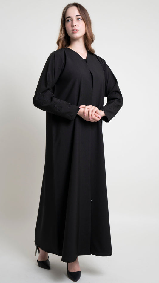 Girl wearing black abaya with floral thread embroidered sleeves with beads