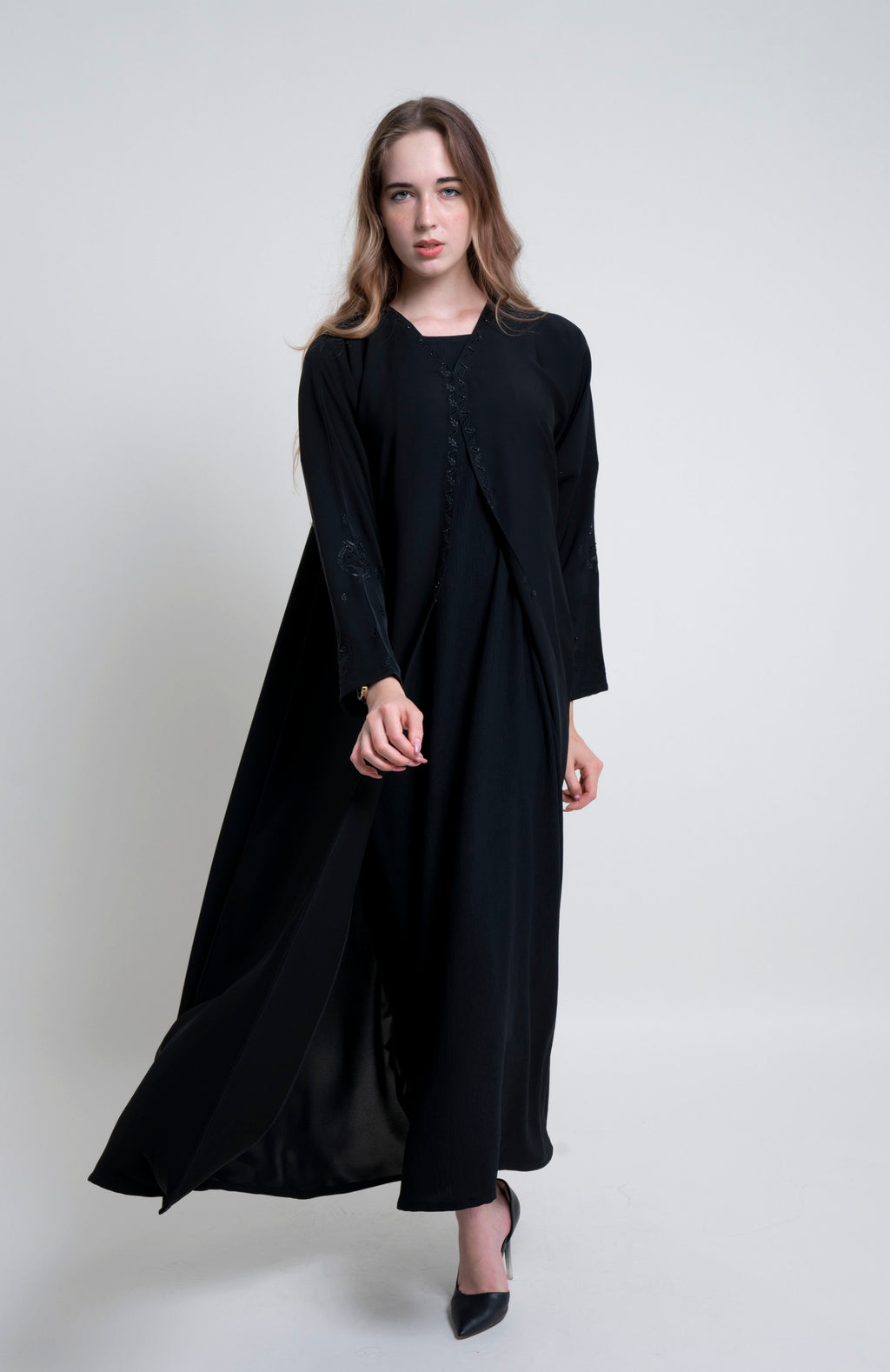 Flow of black abaya with Embroidered Neckline and Floral Motif Sleeves