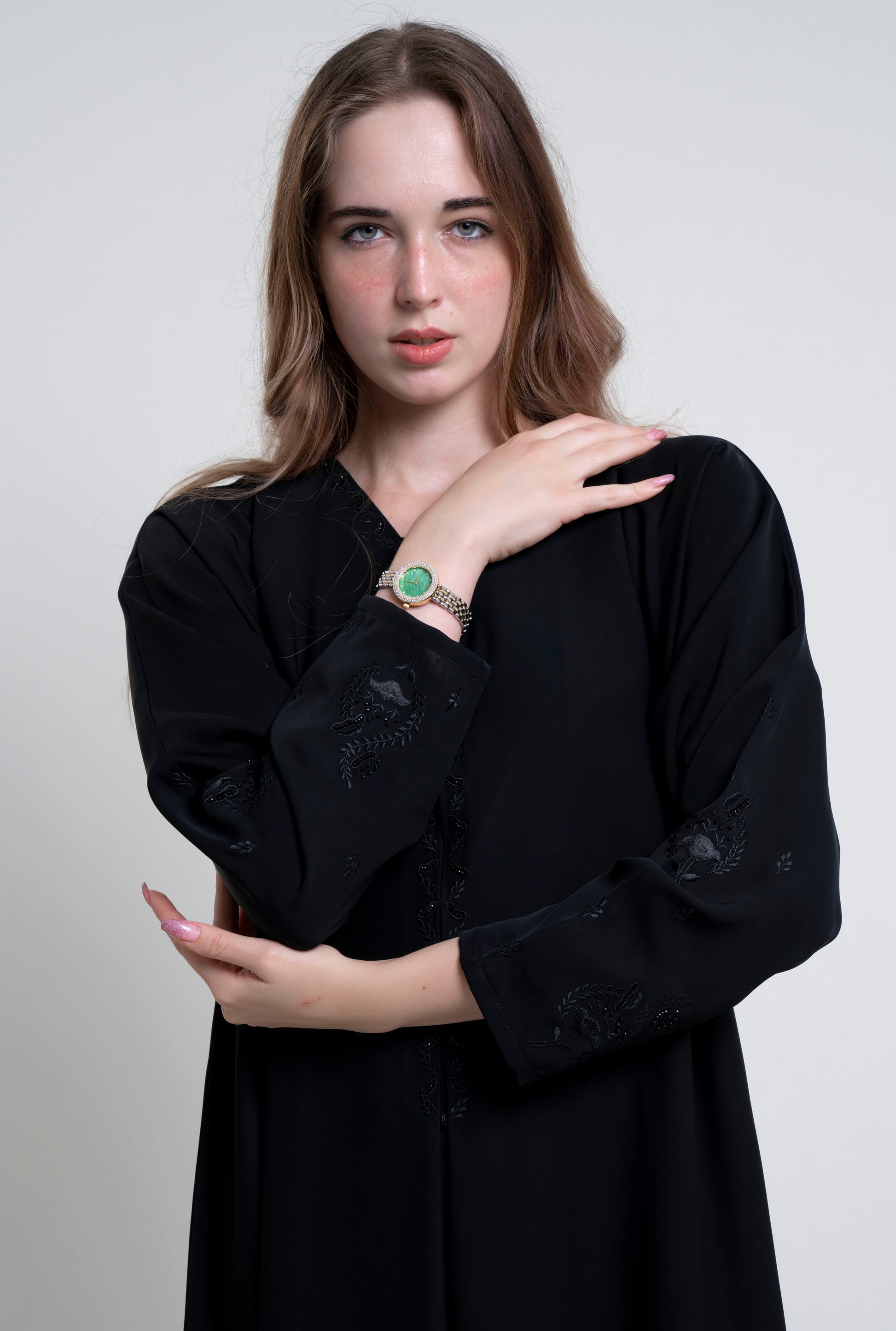 Girl wearing black abaya design with Embroidered Neckline and Floral Motif Sleeves